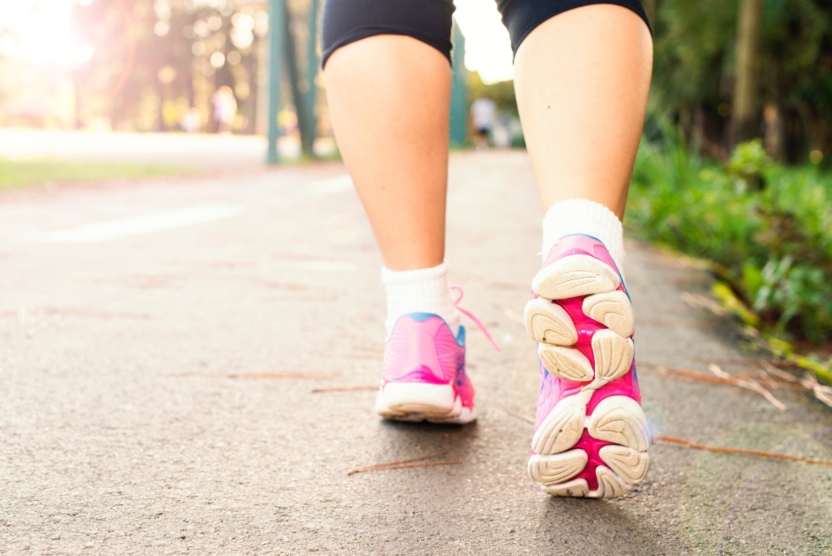 woman wearing pink sneakers walking on the park